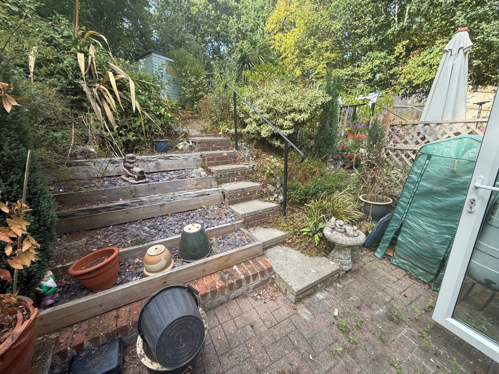 Lot: 131 - TWO-BEDROOM HOUSE FOR INVESTMENT OR OCCUPATION - Lower part of garden with paving
